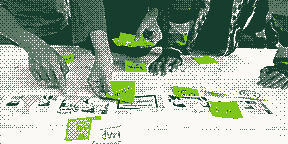A team placing sticky notes on a printed journey map