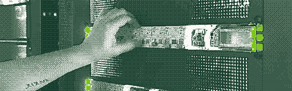 A hand adjusting components in a server rack